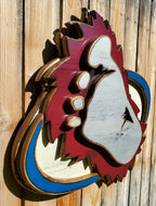 Wooden cutout of a bigfoot logo displayed on a wooden fence