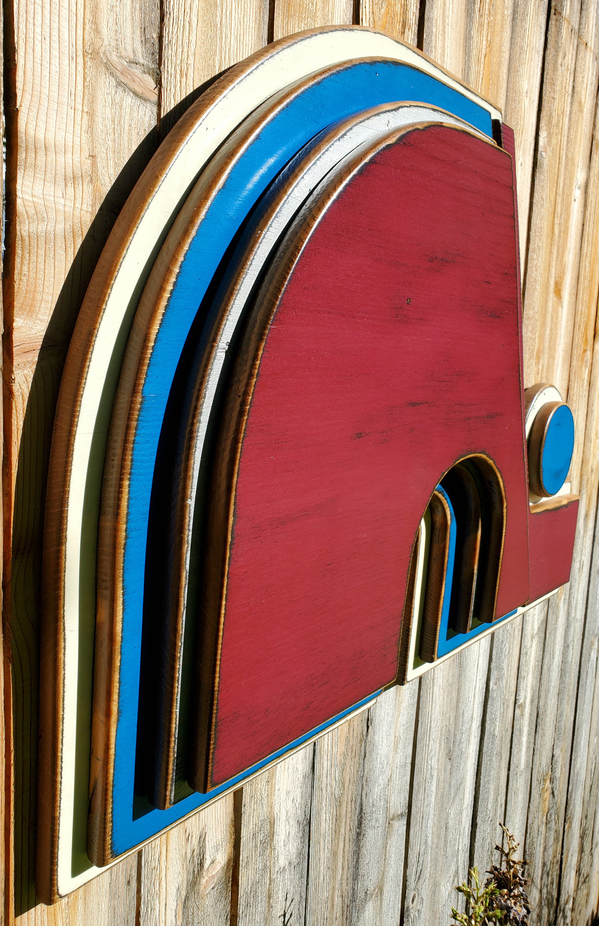 Wooden Nordique logo in 3D, painted in red, blue, and white