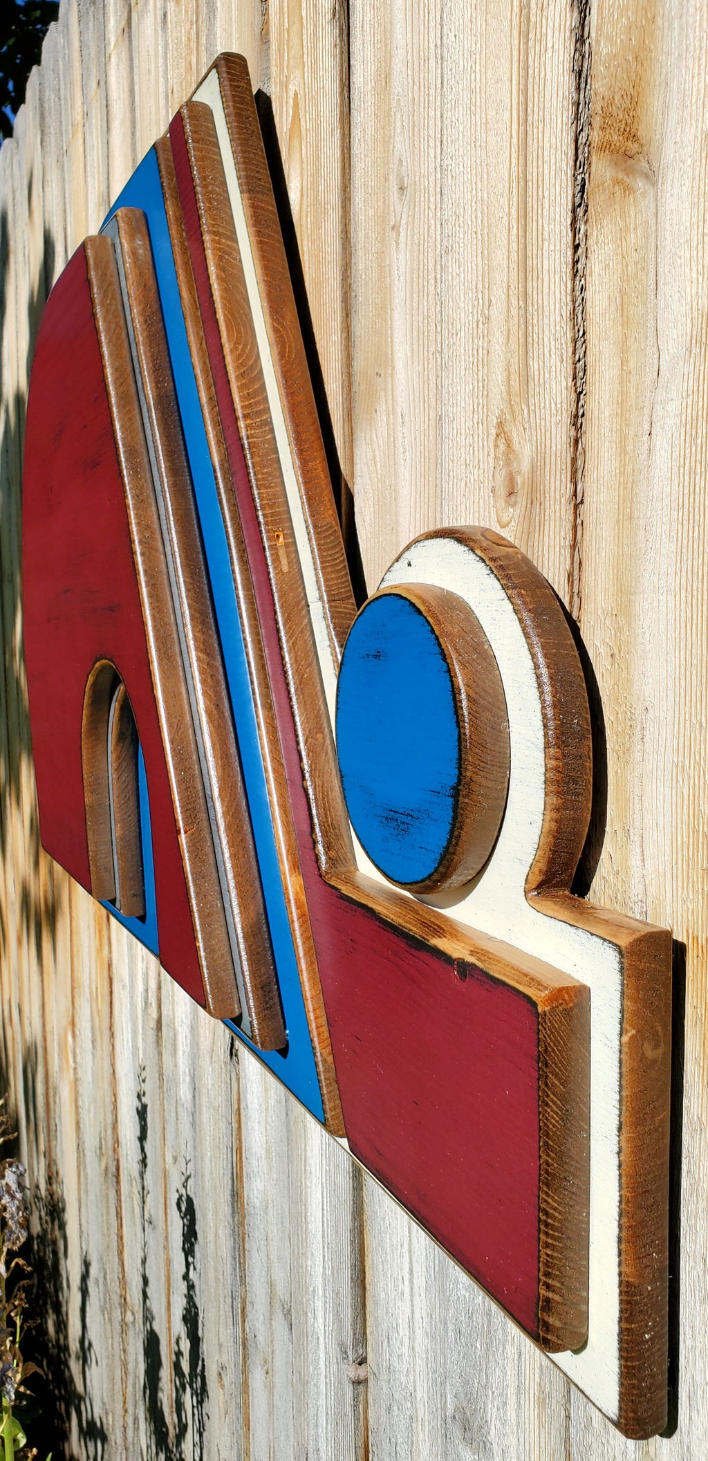 Wooden Nordique logo in 3D, painted in red, blue, and white