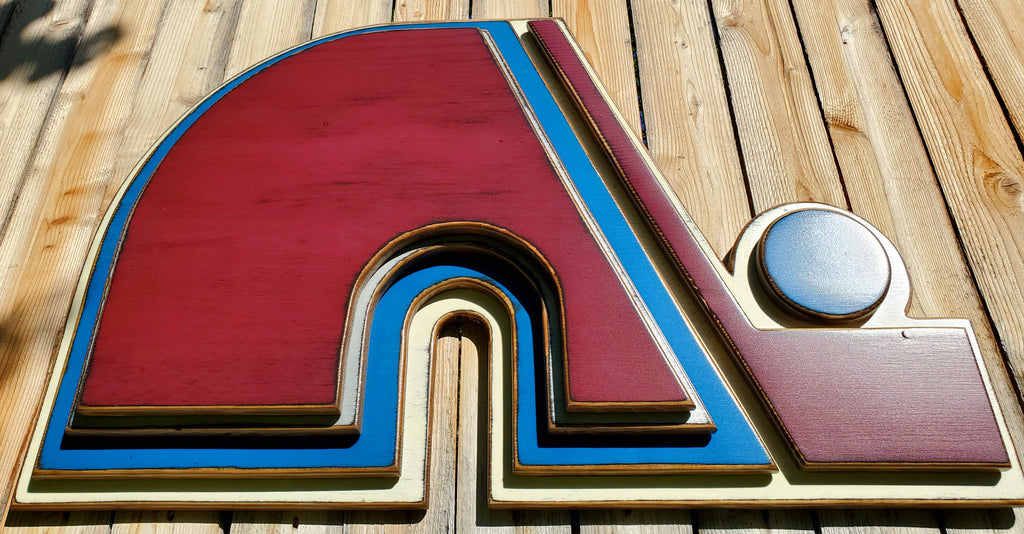 Wooden Nordique logo in 3D, painted in red, blue, and white