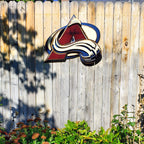 Colorful Avalanche A logo with abstract design hanging from a wooden fence