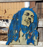 Wooden sculpture of Bob Marley's face and hair in blue and brown tones on a wooden background