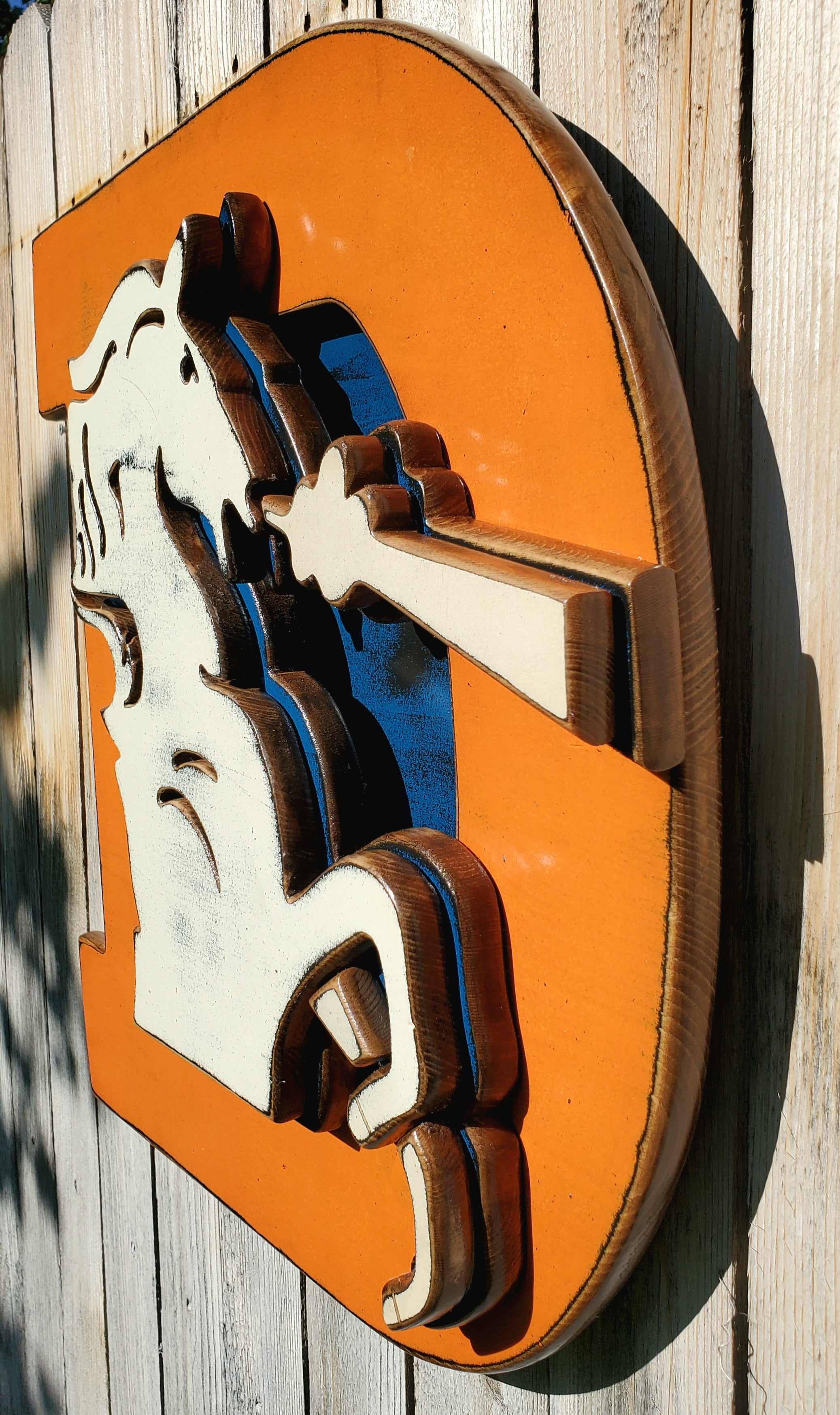 Wooden Broncos Retro "D" logo displayed on a wooden fence
