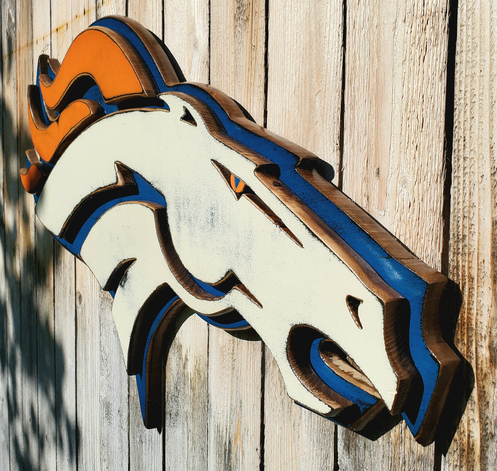 Denver Broncos modern logo displayed on a wooden fence