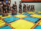 Decorative chess set featuring dog figures on a colorful blue and yellow checkered board