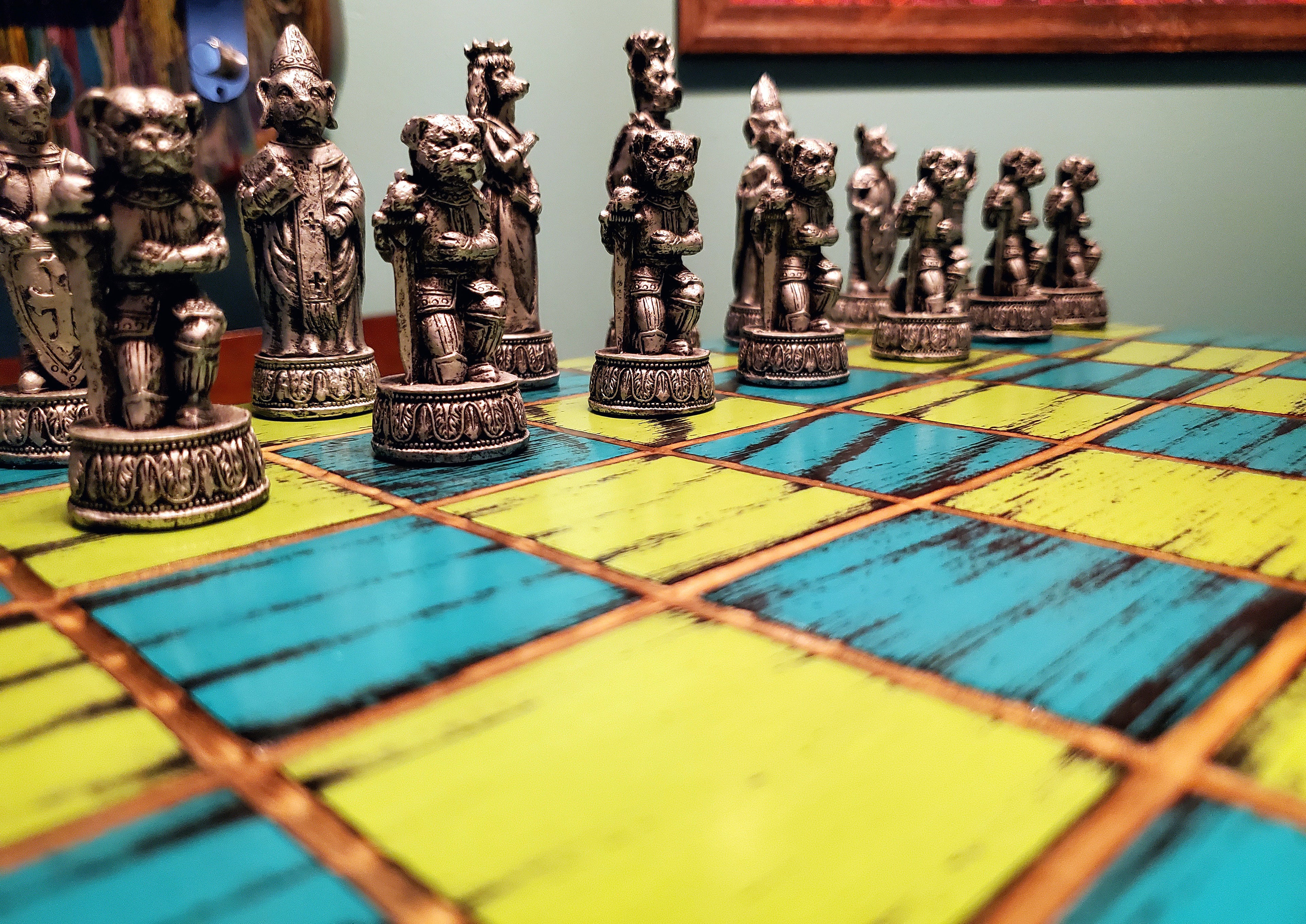 Decorative chess set featuring dog figures on a colorful blue and yellow checkered board