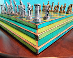 Colorful blue and yellow wooden chessboard with intricately designed chess pieces on a round table