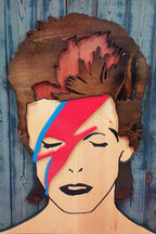 Wooden wall art of David Bowie's Aladdin Sane album cover photographed on a colorful backdrop