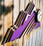 Decorative sign with Colorado Rockies purple mountain design and baseball on a wooden fence background