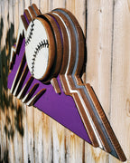 Decorative sign with Colorado Rockies purple mountain design and baseball on a wooden fence background