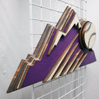 Decorative sign with Colorado Rockies purple mountain design and baseball on a metal grid background