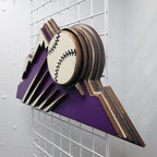 Decorative sign with Colorado Rockies purple mountain design and baseball on a metal grid background