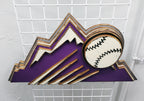 Decorative sign with Colorado Rockies purple mountain design and baseball on a metal grid background